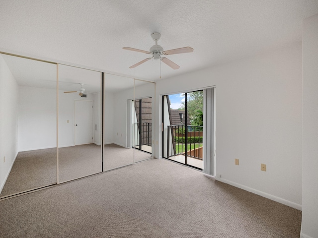 unfurnished bedroom featuring access to exterior, ceiling fan, a textured ceiling, light carpet, and a closet