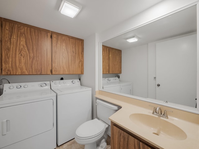 bathroom featuring separate washer and dryer, tile patterned flooring, vanity, and toilet