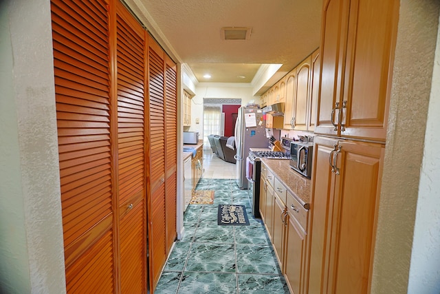 hallway with a textured ceiling and ornamental molding