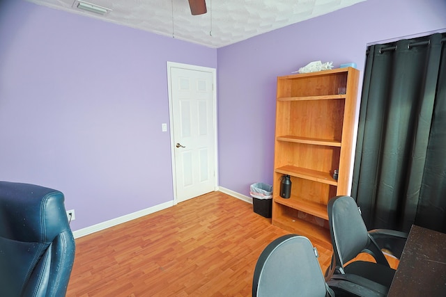 office space featuring ceiling fan, hardwood / wood-style floors, and a textured ceiling