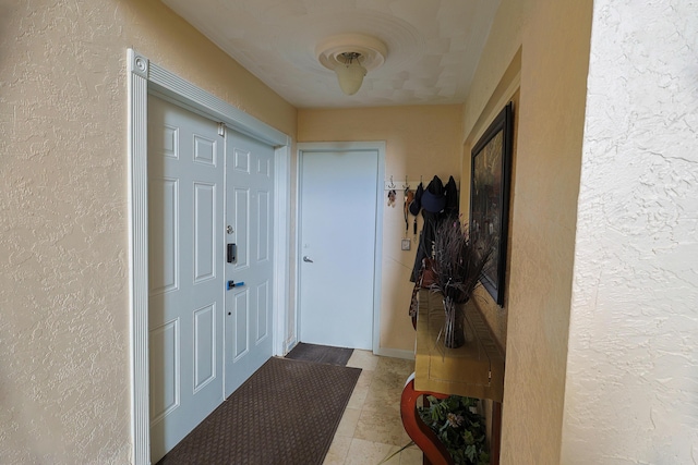 doorway to outside with light tile patterned floors