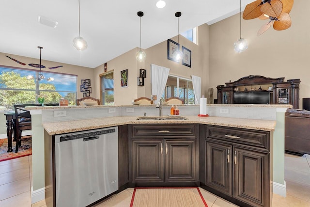 kitchen with stainless steel dishwasher, a towering ceiling, decorative light fixtures, light tile patterned flooring, and dark brown cabinetry