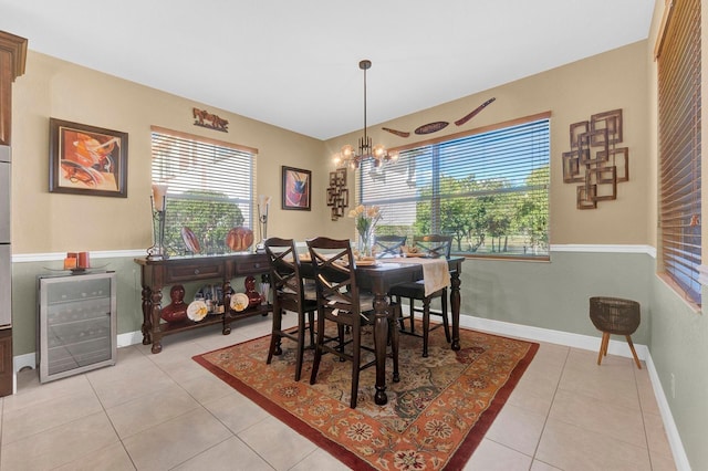 tiled dining area with wine cooler and a chandelier