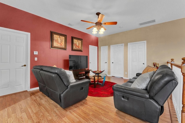 living room featuring light hardwood / wood-style floors and ceiling fan