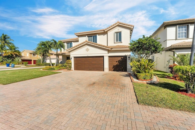 mediterranean / spanish-style house featuring a front yard and a garage