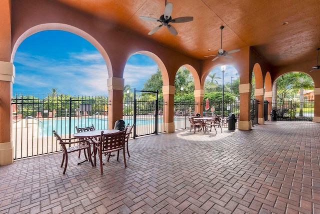 view of patio featuring ceiling fan and a community pool