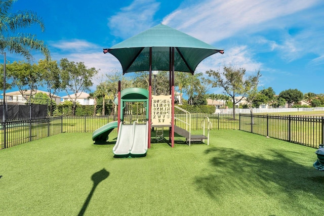 view of jungle gym featuring a lawn