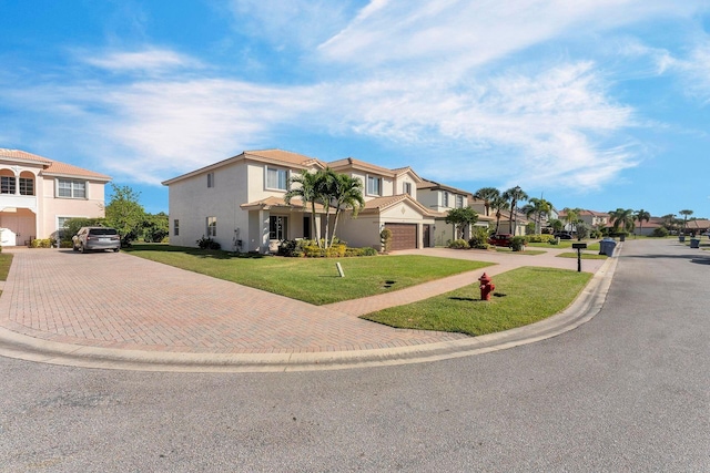 view of front of property featuring a front lawn and a garage