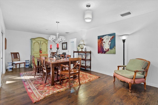 dining room featuring a chandelier and dark hardwood / wood-style floors