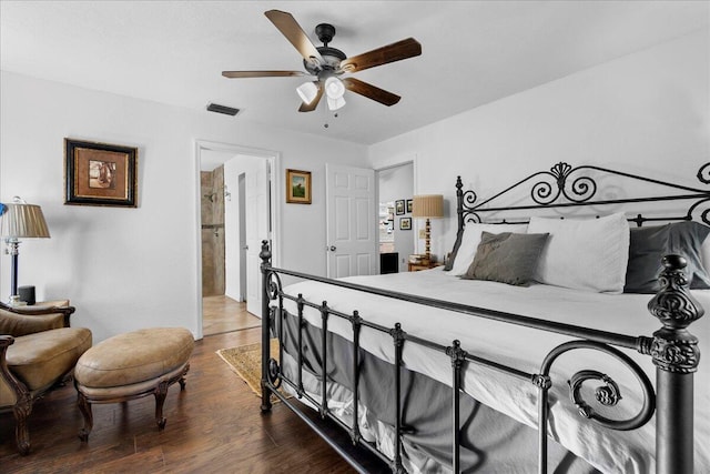 bedroom with hardwood / wood-style floors, ceiling fan, and ensuite bathroom