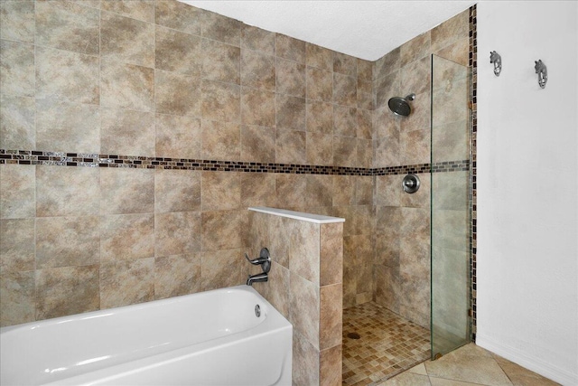 bathroom featuring tile patterned flooring and independent shower and bath