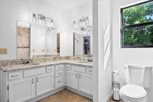 bathroom with tile patterned floors, vanity, and toilet