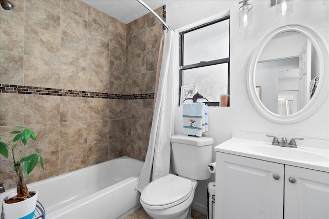 full bathroom featuring shower / bath combo with shower curtain, vanity, and toilet