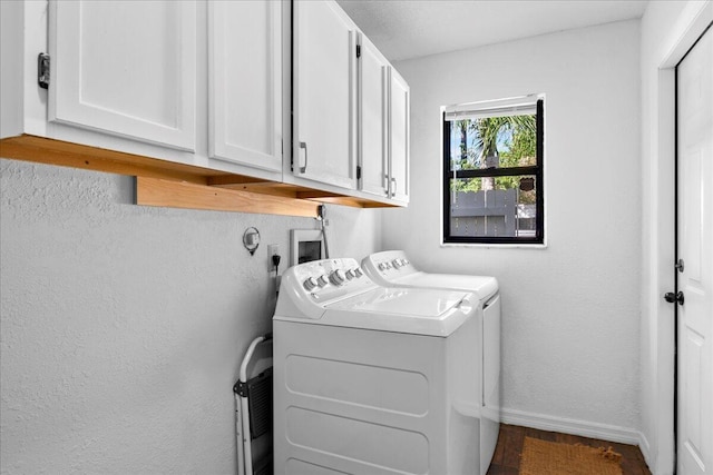 laundry room with washer and dryer and cabinets