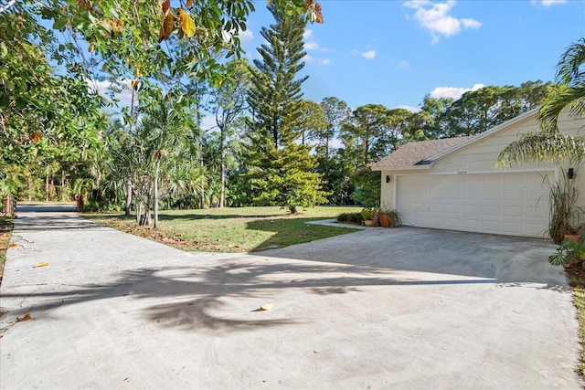 exterior space with a yard and a garage