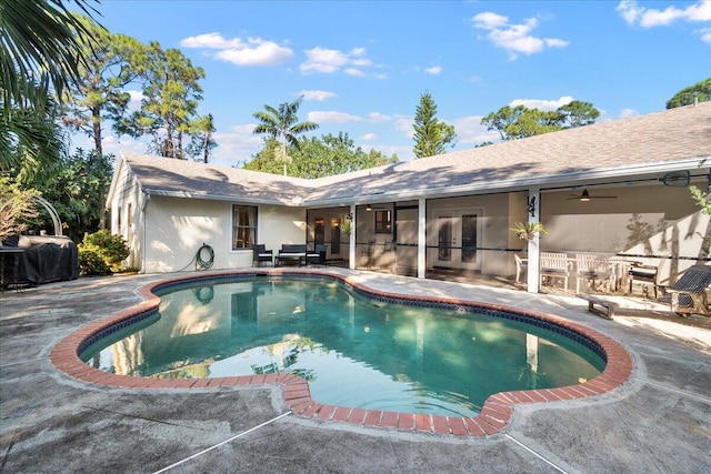 view of swimming pool with a patio, grilling area, and ceiling fan