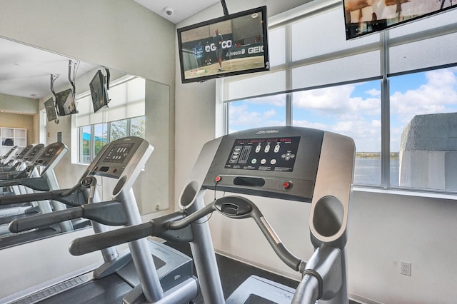 workout area featuring a water view