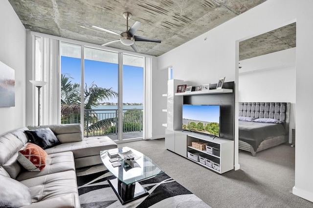 carpeted living room with ceiling fan