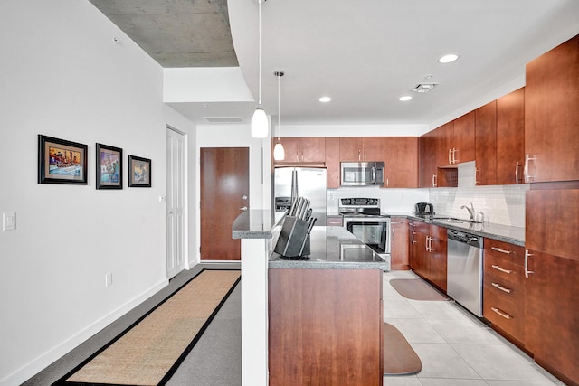 kitchen featuring a breakfast bar, a kitchen island, stainless steel appliances, and decorative light fixtures