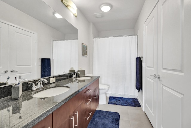 bathroom with toilet, a shower with curtain, vanity, and tile patterned floors