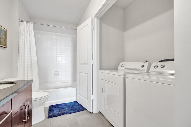 clothes washing area featuring washer and clothes dryer, light tile patterned flooring, and sink