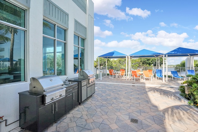 view of patio / terrace with a gazebo, sink, area for grilling, and a grill