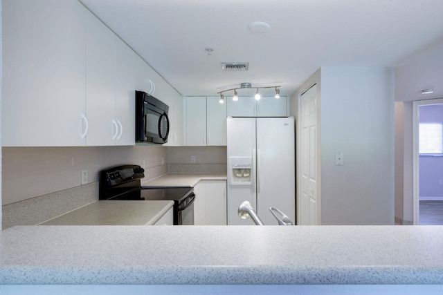 kitchen with white cabinetry and black appliances