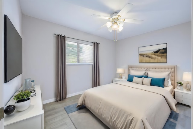 bedroom with ceiling fan and light hardwood / wood-style flooring