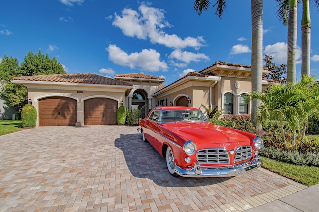 mediterranean / spanish-style home with a garage