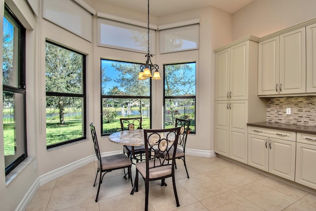 tiled dining area featuring an inviting chandelier