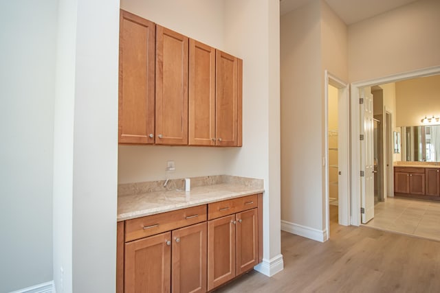 interior space with light stone countertops and light hardwood / wood-style floors