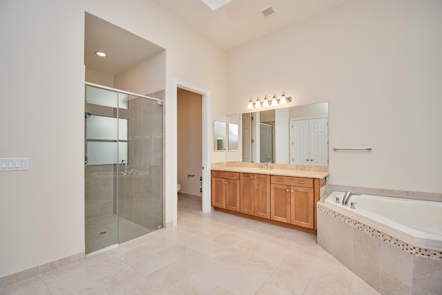 full bathroom with tile patterned floors, vanity, toilet, and independent shower and bath