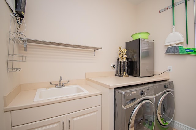 laundry room with separate washer and dryer, sink, and cabinets