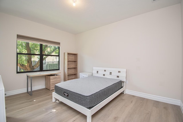 bedroom with light hardwood / wood-style flooring