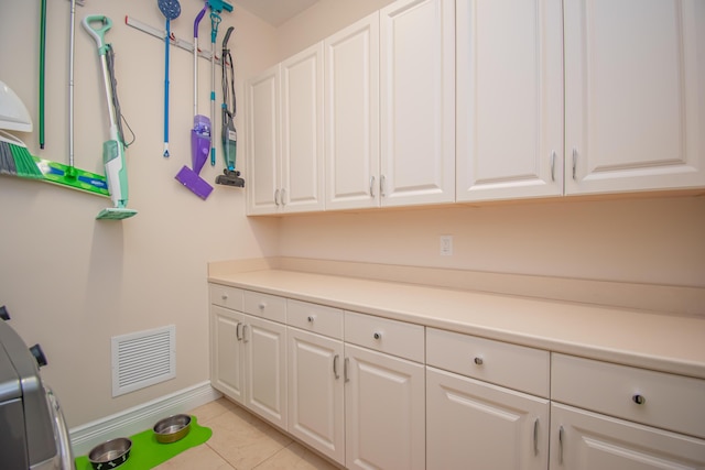 washroom featuring cabinets and light tile patterned floors