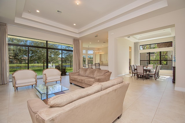 tiled living room with a tray ceiling and a high ceiling