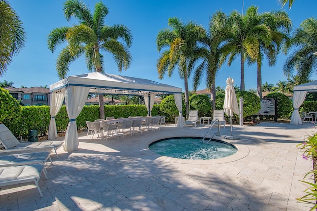 view of swimming pool featuring a gazebo, a hot tub, and a patio area