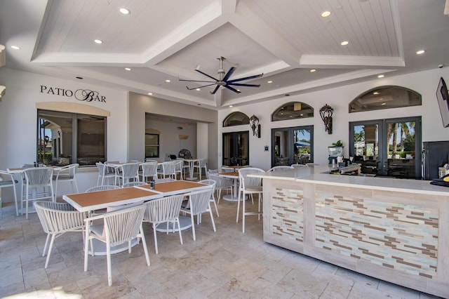 view of patio with ceiling fan and an outdoor bar