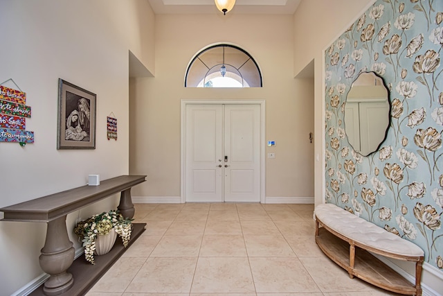 tiled foyer entrance with a high ceiling