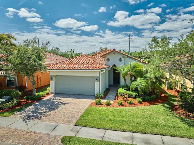 mediterranean / spanish-style home featuring a garage and a front lawn