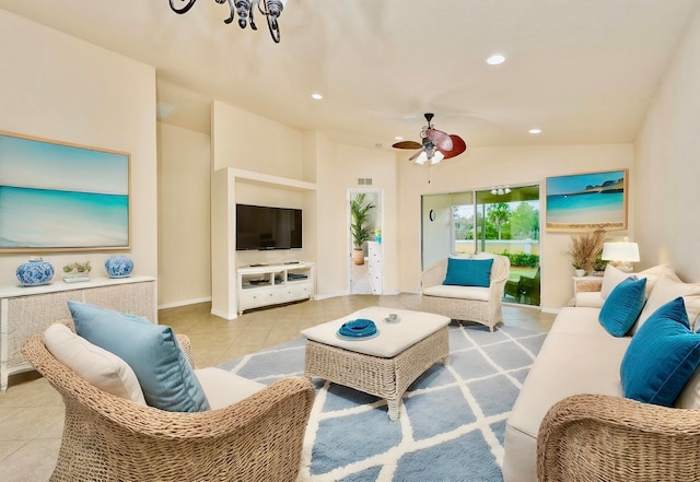 tiled living room with ceiling fan with notable chandelier and vaulted ceiling