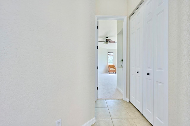 hall featuring light tile patterned flooring