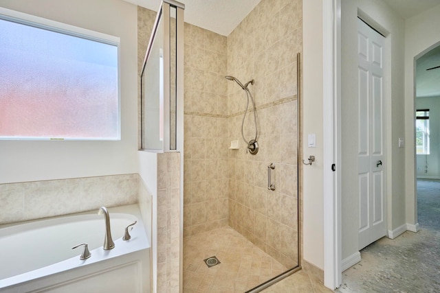 bathroom with plenty of natural light and shower with separate bathtub