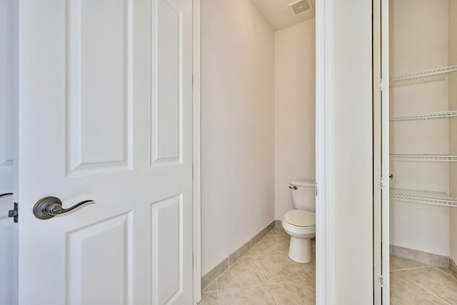 bathroom featuring tile patterned floors and toilet