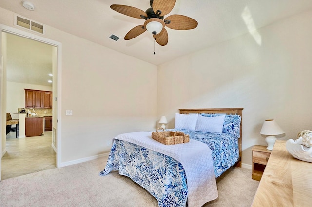 bedroom featuring ceiling fan and light colored carpet