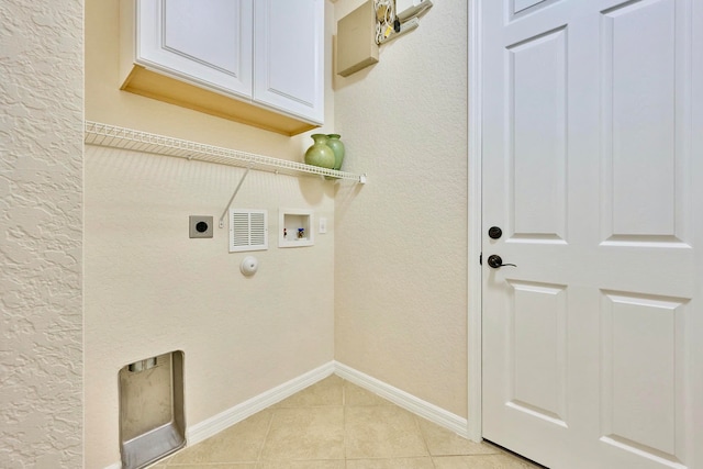 laundry area featuring washer hookup, electric dryer hookup, light tile patterned flooring, and cabinets