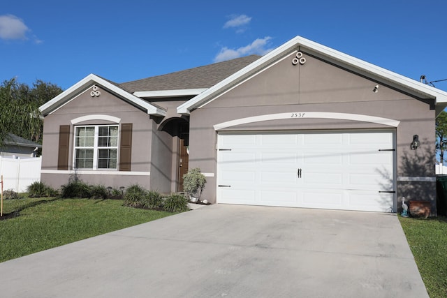 ranch-style house with a front lawn and a garage