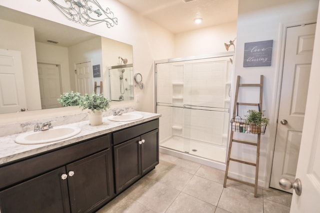 bathroom featuring tile patterned flooring, vanity, and an enclosed shower