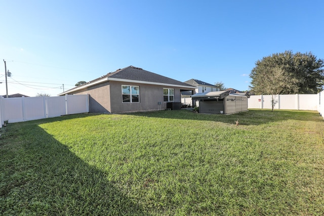 rear view of property featuring a yard