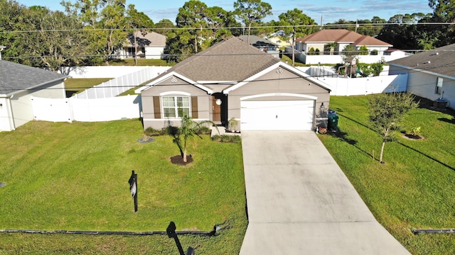 view of front of home featuring a front yard and a garage